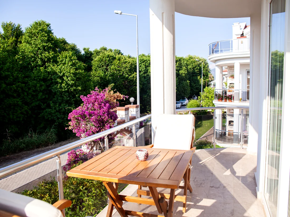Balcony seating with bougainvillea and garden views at Calis Sunstay