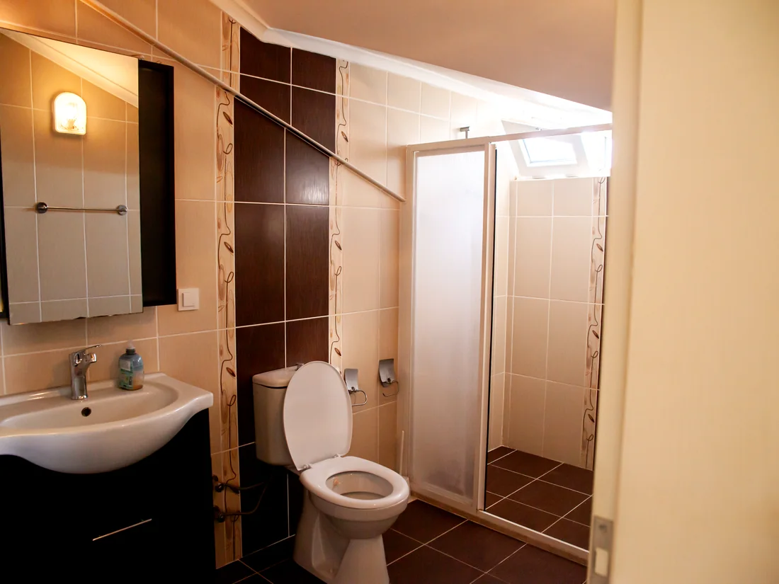 Bathroom with shower and vanity inside the Calis Sunstay apartment
