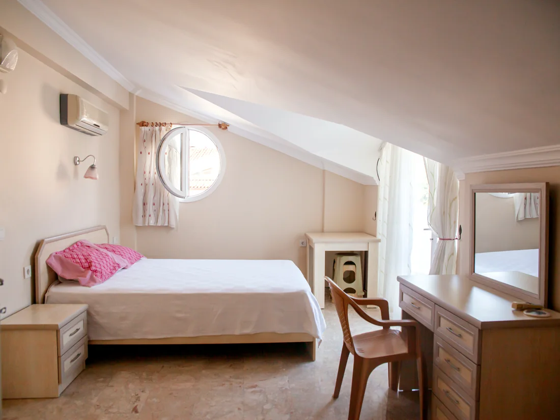 Second bedroom double bed with balcony doors in the Calis Sunstay apartment